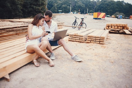 young sport couple walking by the river and uses communication rides a bikeの写真素材