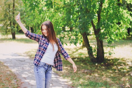 young beautiful girl walking parkの写真素材