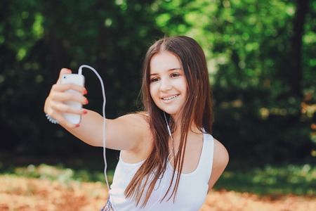 young beautiful girl walking parkの写真素材
