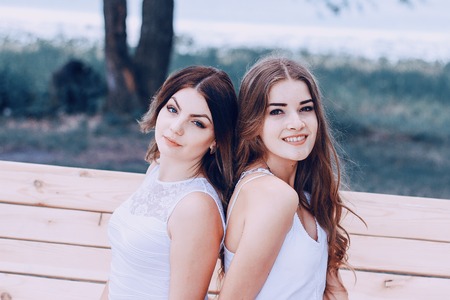 two girls resting on the beachの写真素材