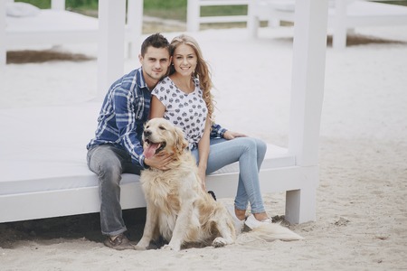 couple walking outdoors with her dogの写真素材