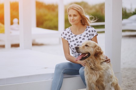 couple walking outdoors with her dogの写真素材