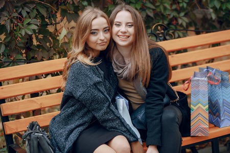 two girls walking city.  shopping and use communicationsの写真素材