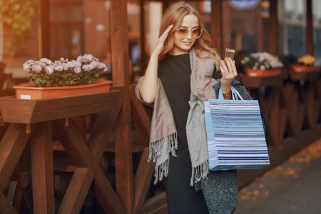 two girls walking city.  shopping and use communicationsの写真素材