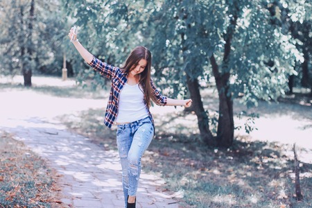 young beautiful girl walking parkの写真素材