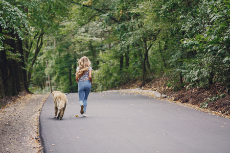 couple walking outdoors with her dogの写真素材