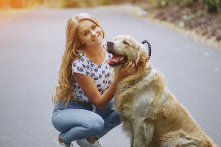couple walking outdoors with her dogの写真素材