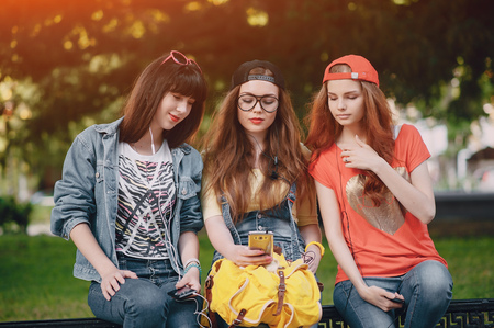 three young girls walking in the parkの写真素材
