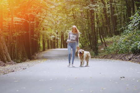 couple walking outdoors with her dogの写真素材