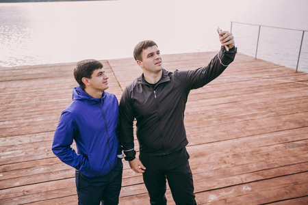 men with phone taking selfieの写真素材