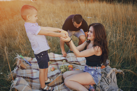 young family with a child have fun outdoorsの写真素材