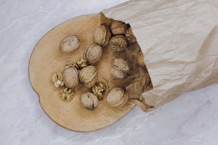 on a white table are nuts in paper bagsの写真素材