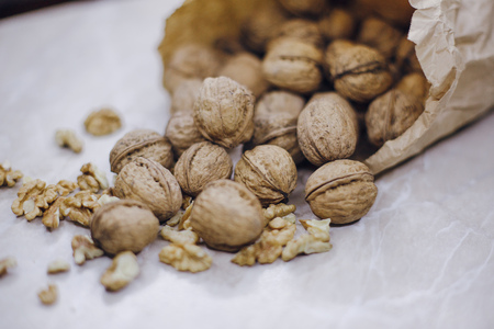 on a white table are nuts in paper bags