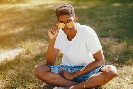 Black guy in a summer parkの写真素材