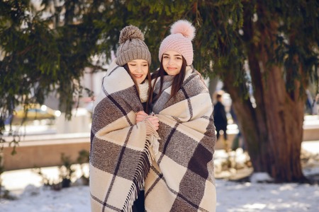 Happy girls in a winter cityの写真素材
