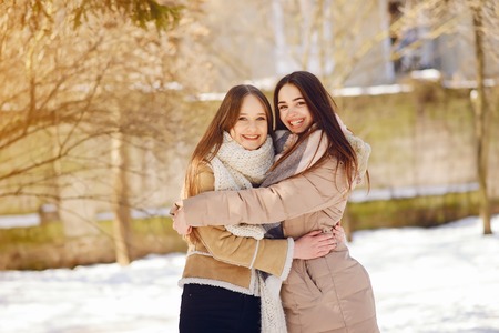 Happy girls in a winter cityの写真素材