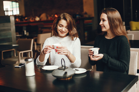 Young beautiful girls drinking coffeeの写真素材