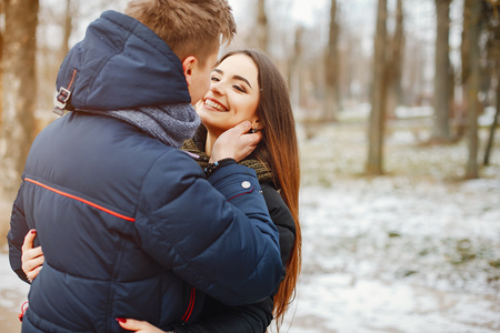 Young Couple in winter park happy and joyfulの写真素材
