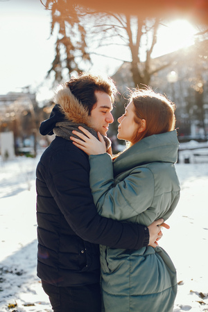 Loving couple walking in a winter parkの写真素材