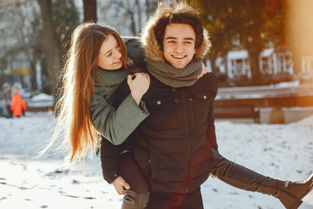 Loving couple walking in a winter parkの写真素材