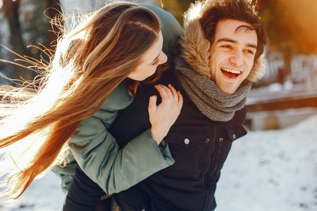 Loving couple walking in a winter parkの写真素材