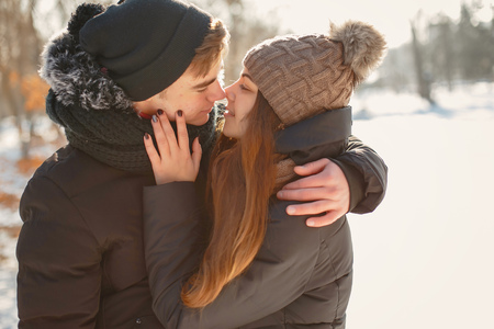 young couple in winter park happy and joyfulの写真素材