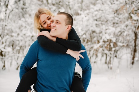 Lovely young couple in winter park happy and joyfulの写真素材