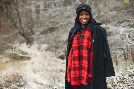 Elegant black girl in a winter park