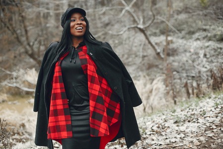 Elegant black girl in a winter parkの写真素材