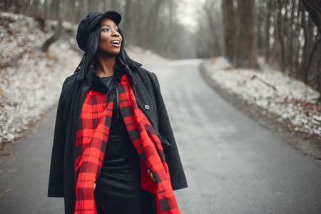 Elegant black girl in a winter parkの写真素材