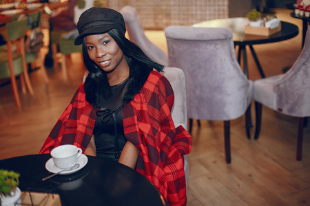Elegant black girl in a cafeの写真素材
