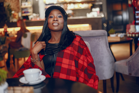 Elegant black girl in a cafeの写真素材