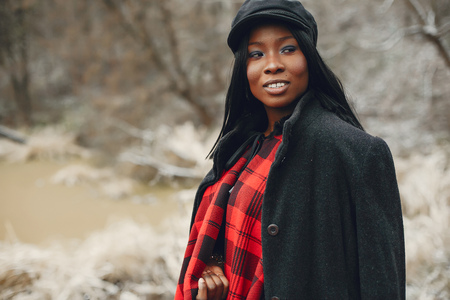 Elegant black girl in a winter parkの写真素材