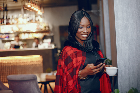 Elegant black girl in a cafeの写真素材