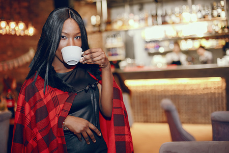 Elegant black girl in a cafeの写真素材