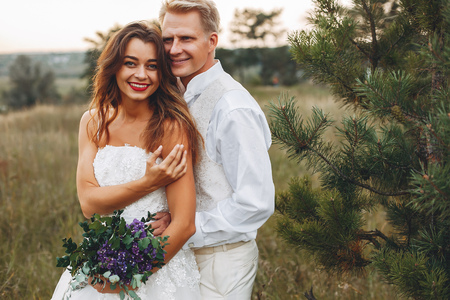 Beautiful wedding couple in a summer fieldの写真素材