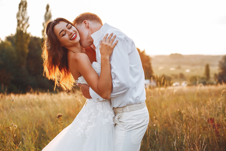 Beautiful wedding couple in a summer fieldの写真素材