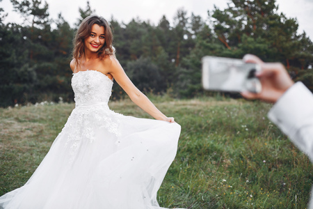 Beautiful wedding couple in a summer fieldの写真素材