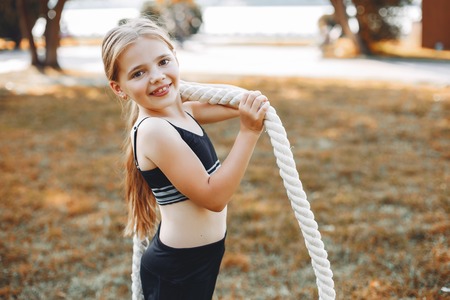 Little sports girl in a summer parkの写真素材