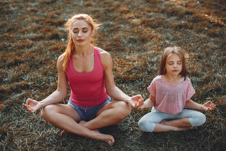 Sports family in a summer parkの写真素材