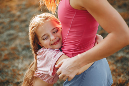 Sports family in a summer parkの写真素材