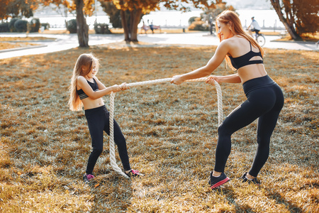 Sports family in a summer parkの写真素材