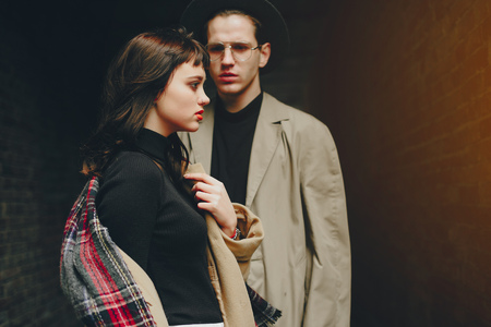 A trendy couple in a gloomy city