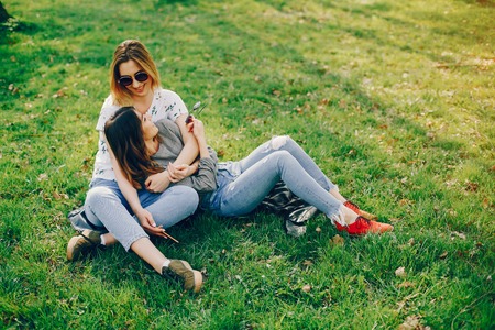 two girls in a summer parkの写真素材