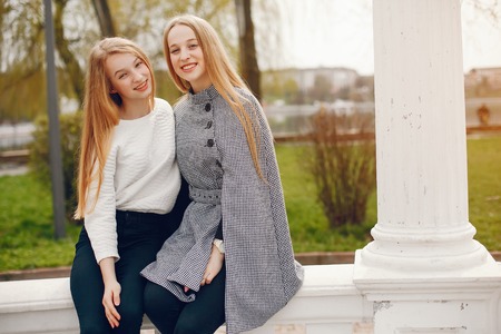 two pretty sisters in a parkの写真素材