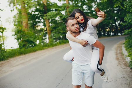 Beautiful couple spend time in a summer parkの写真素材