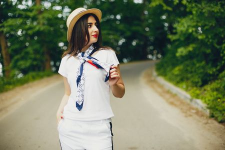 Cute girl walking in a summer parkの写真素材