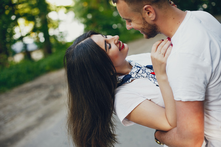 Beautiful couple spend time in a summer parkの写真素材