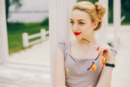 Yound and pretty girl in a summer parkの写真素材