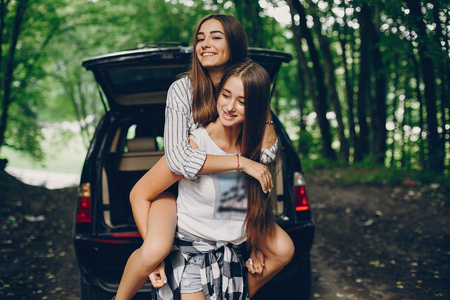Two girls near carの写真素材